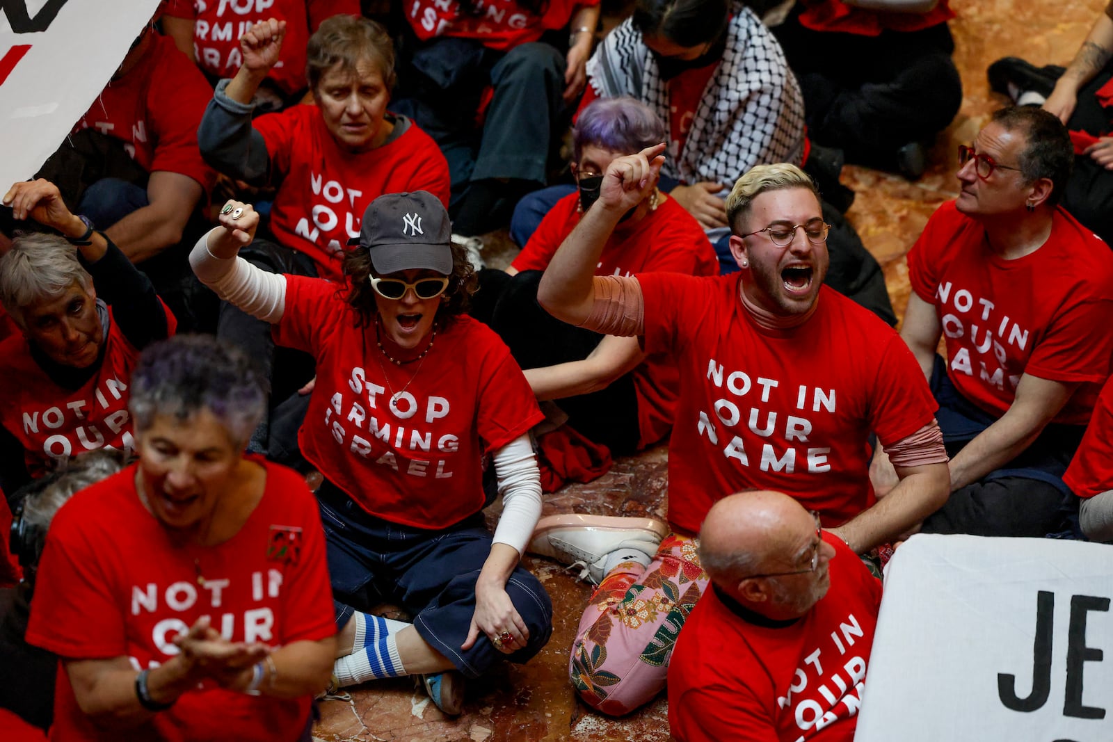 Demonstrators from the group, Jewish Voice for Peace, protest inside Trump Tower in support of Columbia graduate student Mahmoud Khalil, Thursday, March 13, 2025, in New York. (AP Photo/Yuki Iwamura)