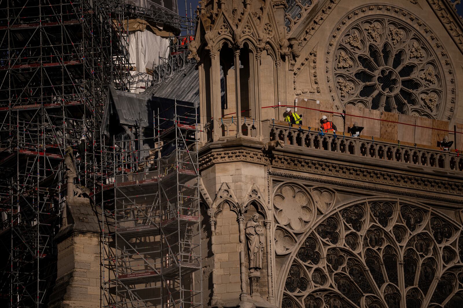 Workers stand on Notre-Dame cathedral in Paris, Wednesday, Nov. 20, 2024. (AP Photo/Louise Delmotte)