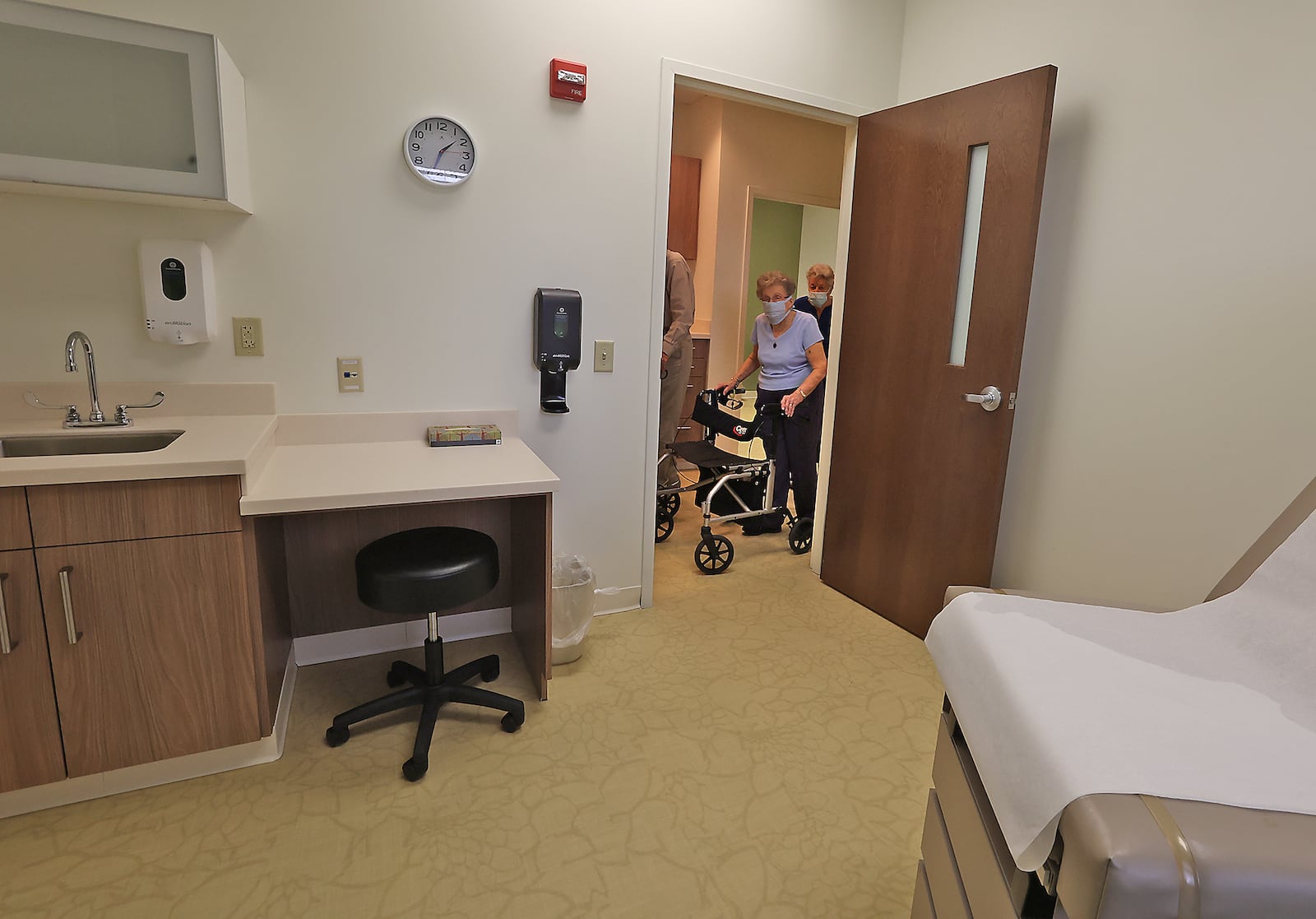 Masonic Community residents tour the new health clinic on the Masonic Communty campus Monday, April 4, 2022. The clinic is a partnership between the Masonic Community and Premier Health. A ribbon cutting ceremony was held Monday with officials from both organizations speaking before the clinic was open for tours. BILL LACKEY/STAFF