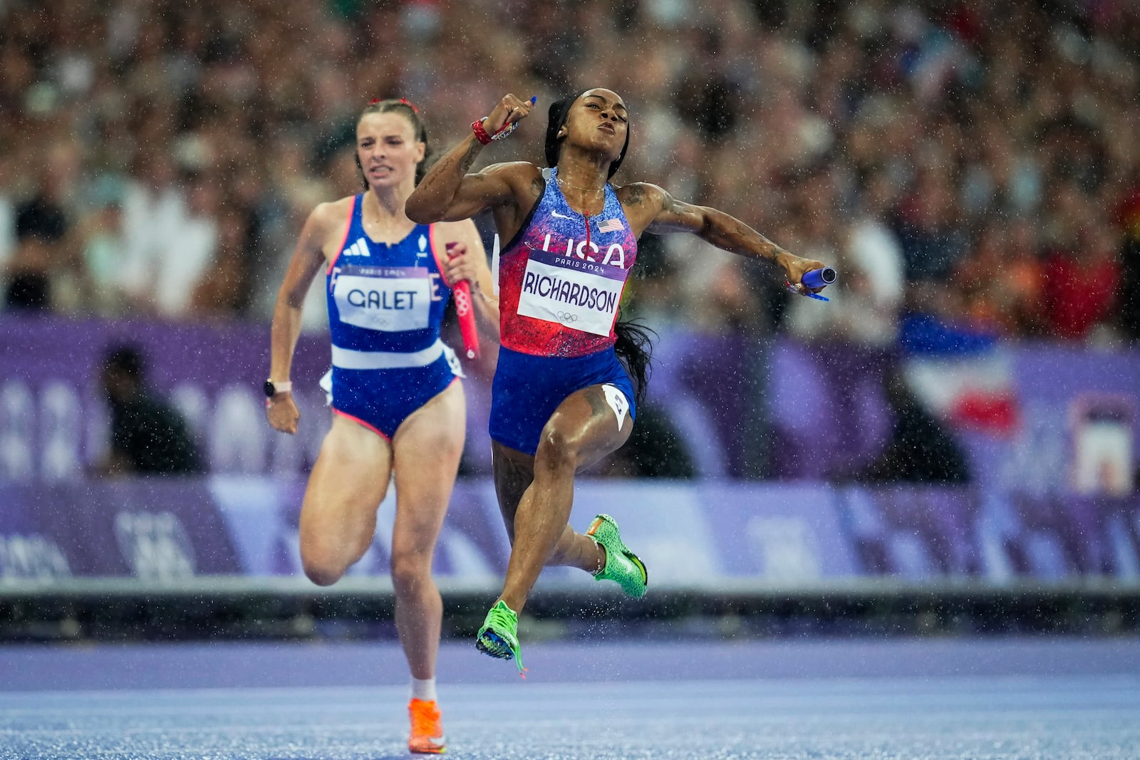 FILE - Sha'carri Richardson, of the U.S., crosses the finish line to win the women's 4 x 100 meters relay final at the Summer Olympic Games in Saint-Denis, France, Aug. 9, 2024. (AP Photo/Ashley Landis, File)