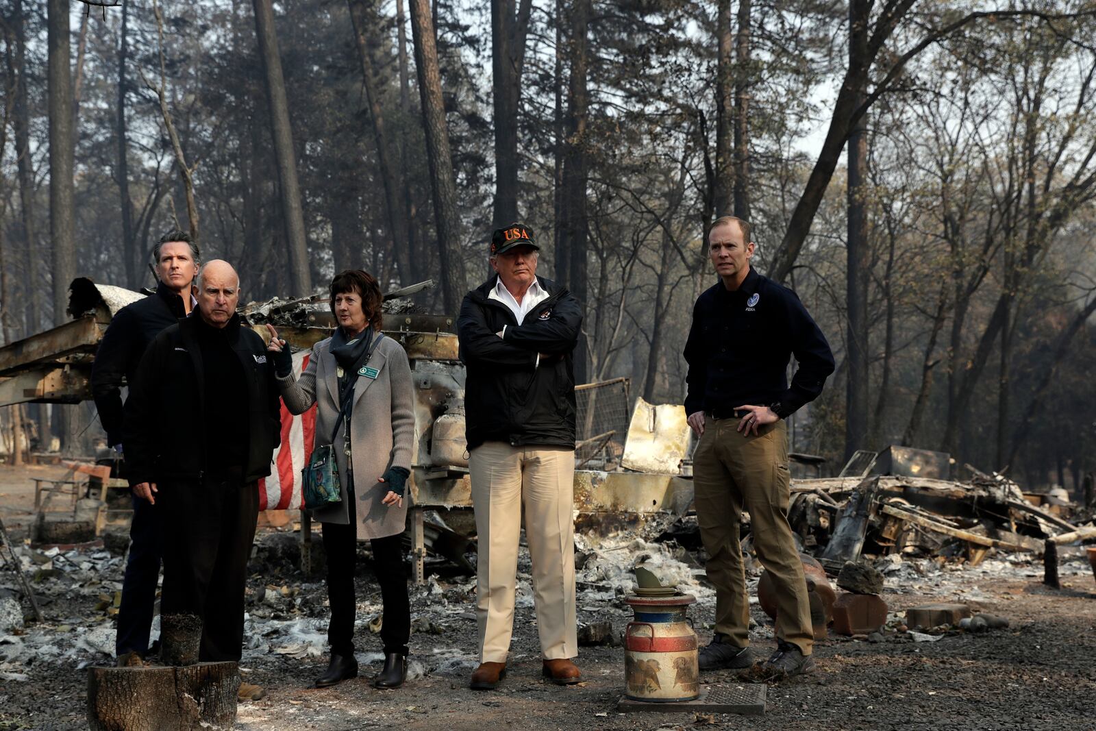 FILE - President Donald Trump talks with, from left, Gov.-elect Gavin Newsom, California Gov. Jerry Brown, Paradise Mayor Jody Jones and FEMA Administrator Brock Long during a visit to a neighborhood destroyed by the wildfires in Paradise, Calif., Nov. 17, 2018. (AP Photo/Evan Vucci, File)