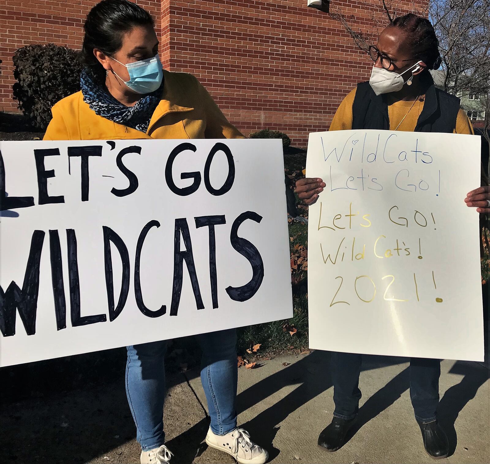 People gather outside of Rocking Horse Community Health Center Friday morning to show support to Springfield Highschool Football players heading to the state championship game. HASAN KARIM/STAFF