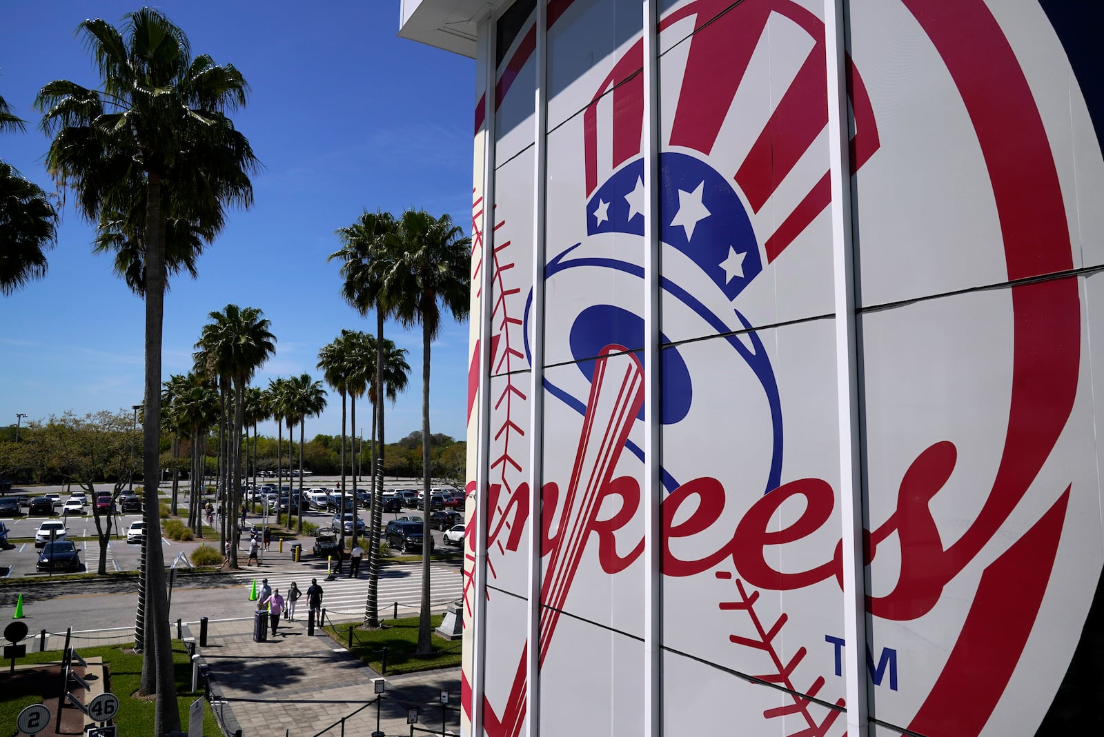 FILE - Fans arrive at George M. Steinbrenner Field for a spring training exhibition baseball game between the New York Yankees and the Pittsburgh Pirates in Tampa, Fla., Saturday, March 13, 2021. (AP Photo/Gene J. Puskar