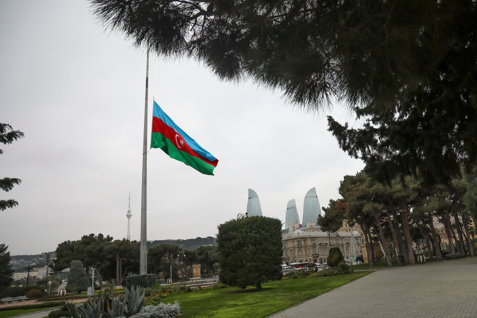 Azerbaijan's national flag at half-mast in the memory of victims of the Azerbaijan Airlines' Embraer 190 that crashed near the Kazakhstan's airport of Aktau, is seen in the center of Baku, Azerbaijan, Thursday, Dec. 26, 2024. (AP Photo/Aziz Karimov)