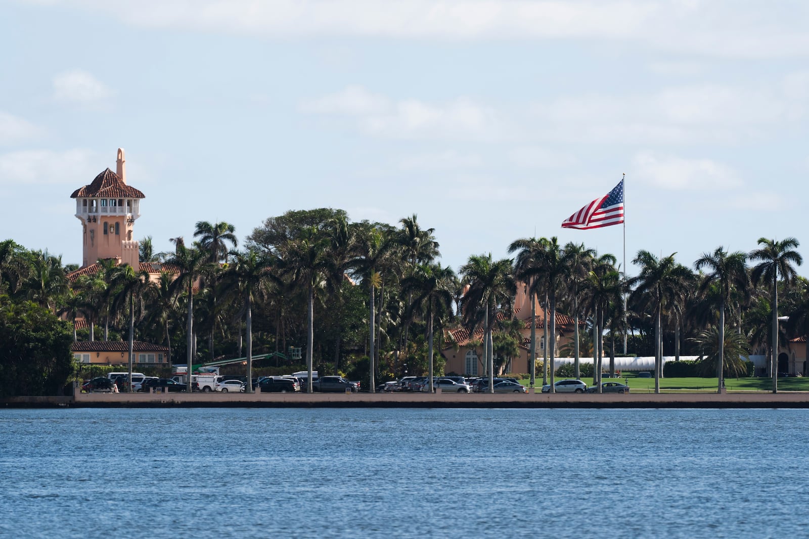 The U.S. flag is shown at the Mar-a-Lago compound in Palm Beach, Fla., while a U.S. Coast Guard boat patrols around the vicinity, Monday, Jan. 13, 2025. U.S. flags at President-elect Donald Trump's private Mar-a-Lago club are back to flying at full height. Flags are supposed to fly at half-staff through the end of January out of respect for former President Jimmy Carter, who died Dec. 29. (AP Photo/Manuel Balce Ceneta)