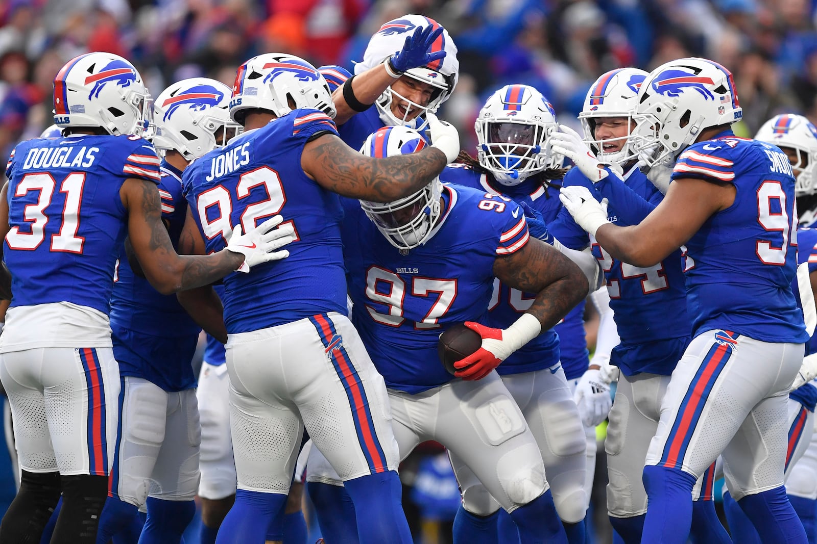 Buffalo Bills defensive tackle Jordan Phillips (97) celebrates with teammates after making an interception against the New York Jets during the first half of an NFL football game, Sunday, Dec. 29, 2024, in Orchard Park, N.Y. (AP Photo/Adrian Kraus)