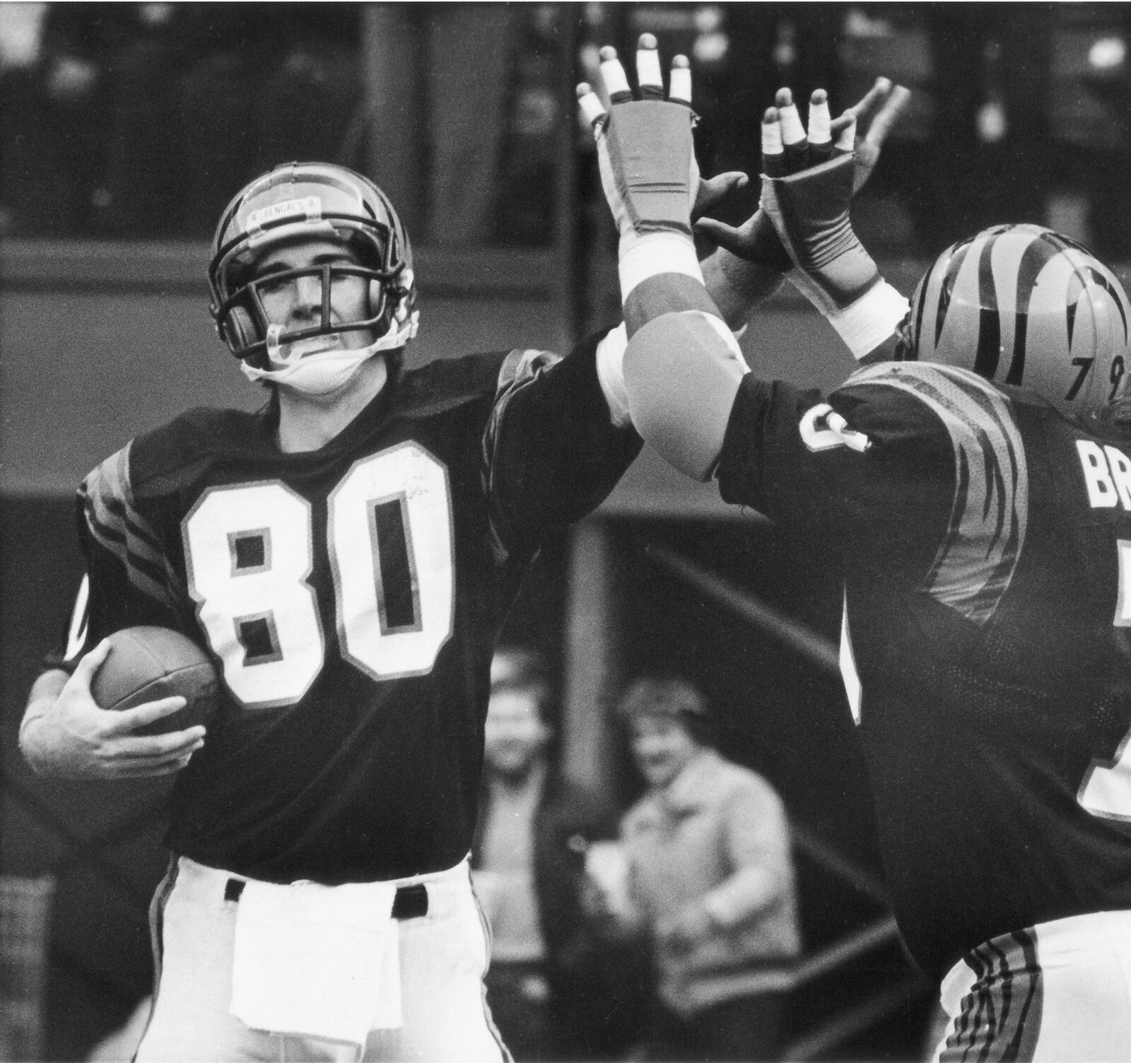 Cincinnati Bengals wide receiver Cris Collinsworth receives congratulations from teammate Ross Browner after catching a first quarter touchdown pass during their game with Atlanta Falcons at Riverfront Stadium in Cincinnati, Nov. 26, 1984. The bengals beat the Falcons 35-14. (AP Photo/Rob Burns)