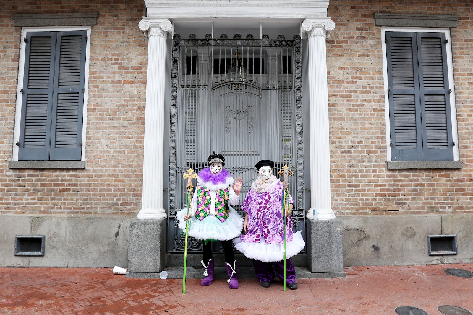 FILE - Jeff Thomas and Shelton Pollet find a rare peaceful spot on Bourbon Street during Mardi Gras festivities in New Orleans, Feb. 25, 2020. (AP Photo/Rusty Costanza, File)