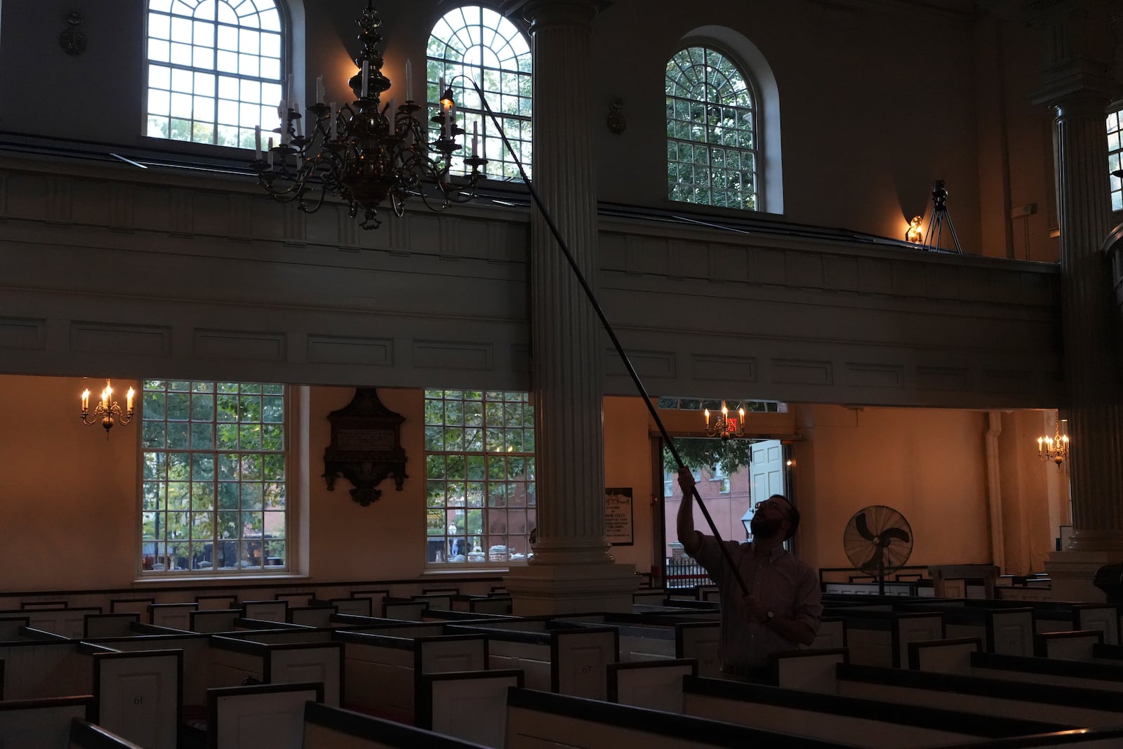 Christ Church congregant Johannes Du Toit lights a chandelier for a Blessing of the Animals candlelight service ceremony in honor of St. Francis at Philadelphia’s Christ Church on Sunday, Oct. 6, 2024. (AP Photo/Luis Andres Henao)