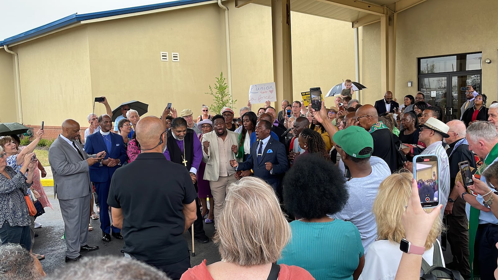 Attendees sing during a prayer vigil advocating for the Springfield Haitian community, held Sept. 22, 2024 at Greater Grace Temple. Local Haitians, including Dernio Desauguste, also sang Haiti's national anthem. SAM WILDOW