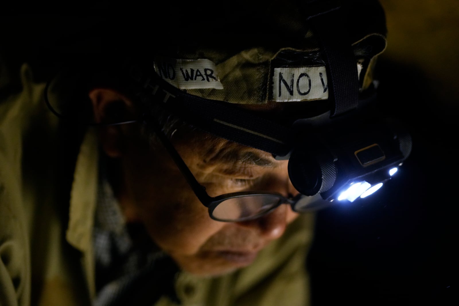 Takamatsu Gushiken, a "gamafuya," an Okinawa dialect meaning a person who digs in a cave, searches in a cave for the remains of those who died during the Battle of Okinawa towards the end of the World War II in 1945, in Itoman, on the main island of the Okinawa archipelago, southern Japan, Saturday, Feb. 15, 2025. (AP Photo/Hiro Komae)