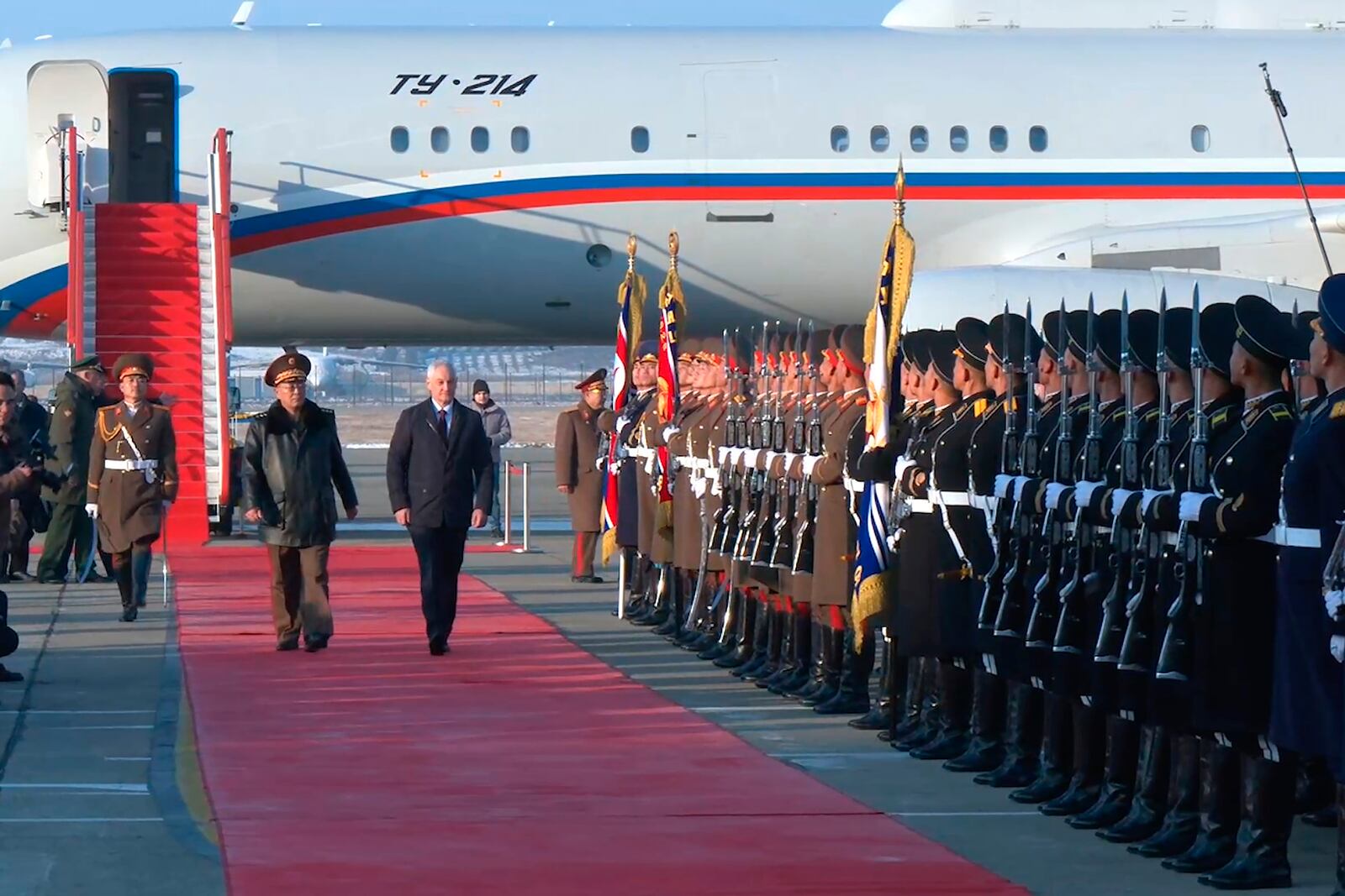 In this photo taken from a video released by Russian Defense Ministry press service, Russian Defense Minister Andrei Belousov, right on the red carpet, is welcomed by North Korean Defense Minister No Kwang Chol, left on the red carpet, upon his arrival at Pyongyang International Airport outside of Pyongyang, North Korea Friday, Nov. 29, 2024. (Russian Defense Press Service via AP)