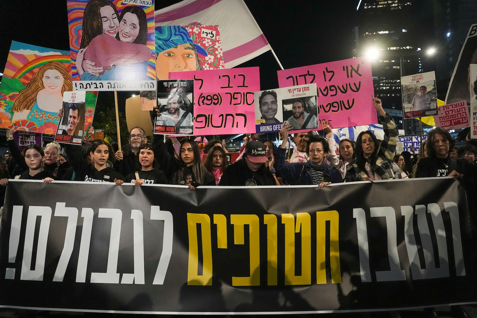 Israelis protest against Prime Minister Benjamin Netanyahu's government and call for the release of hostages held in the Gaza Strip by the Hamas militant group, in Tel Aviv, Israel, Saturday, Dec. 14, 2024. (AP Photo/Tsafrir Abayov)