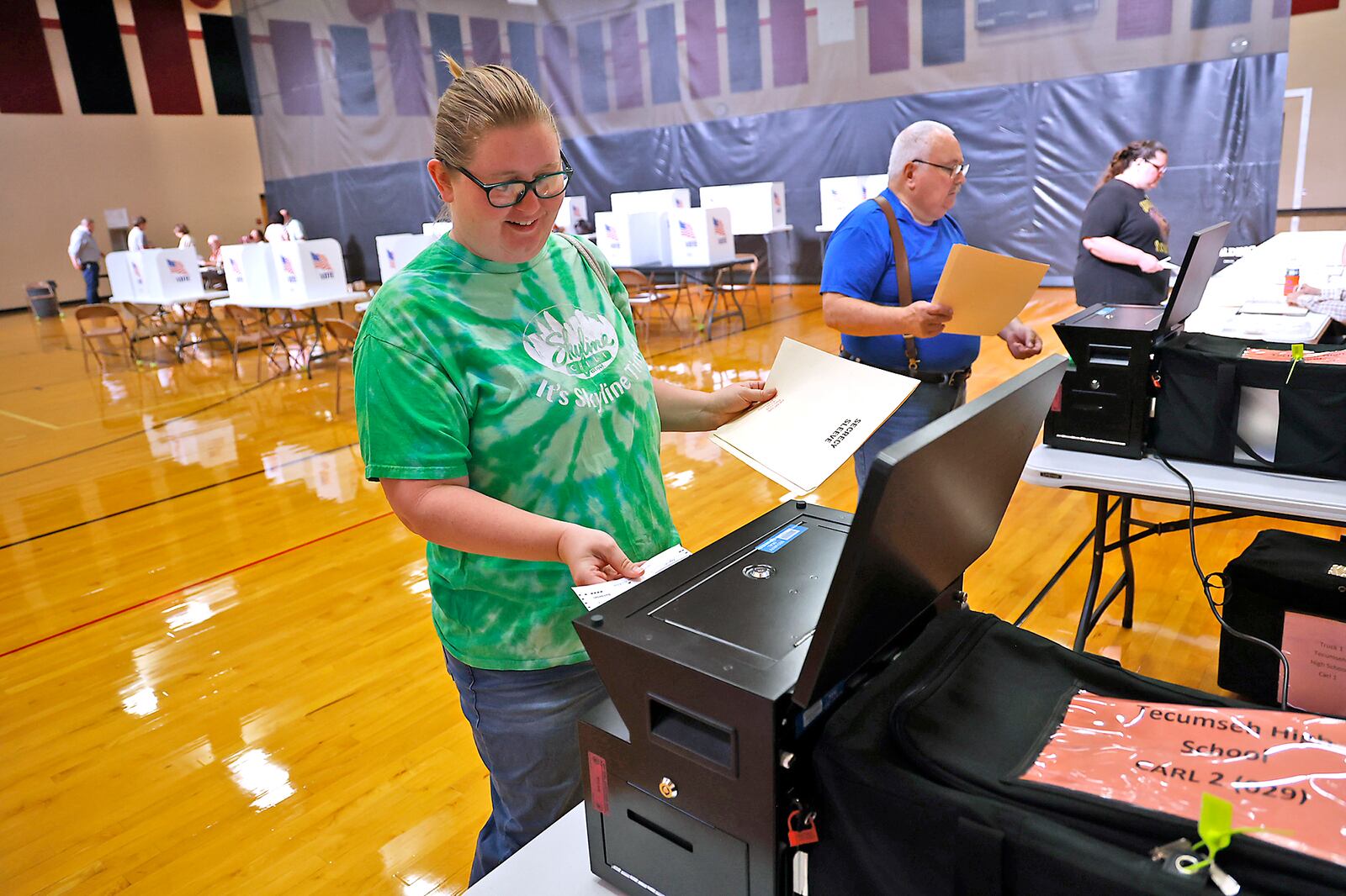 Katy Parker slides her ballot into the voting machine after voting at Tecumseh High School Tuesday, August 8, 2023. BILL LACKEY/STAFF