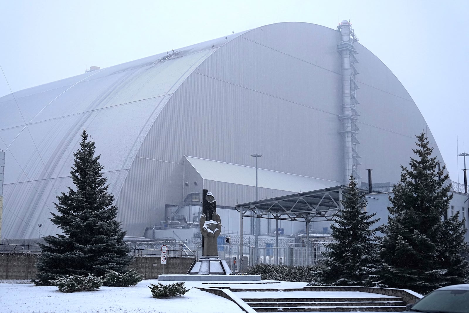 A view of the containment vessel that protects the remains of reactor number four at the former Chernobyl nuclear power plant and built to contain radiation, after a drone attack, Ukraine, Friday, Feb. 14, 2025. (AP Photo/Efrem Lukatsky)