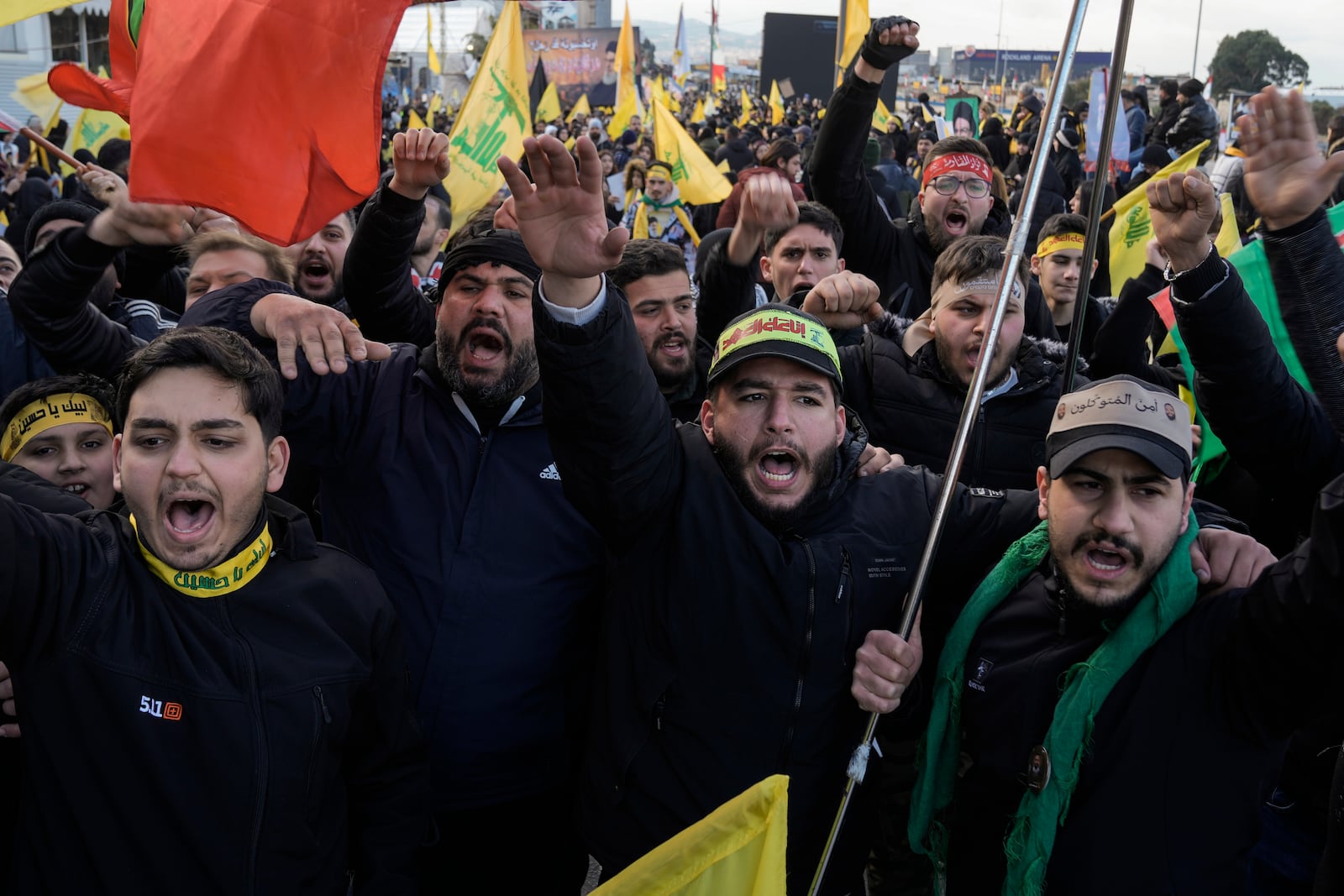 Mourners chant slogans as they gather along a highway for the funeral procession of Lebanon's former Hezbollah leaders, Hassan Nasrallah and his cousin and successor, Hashem Safieddine, in Beirut, Lebanon, Sunday, Feb. 23, 2025. (AP Photo/Bilal Hussein)