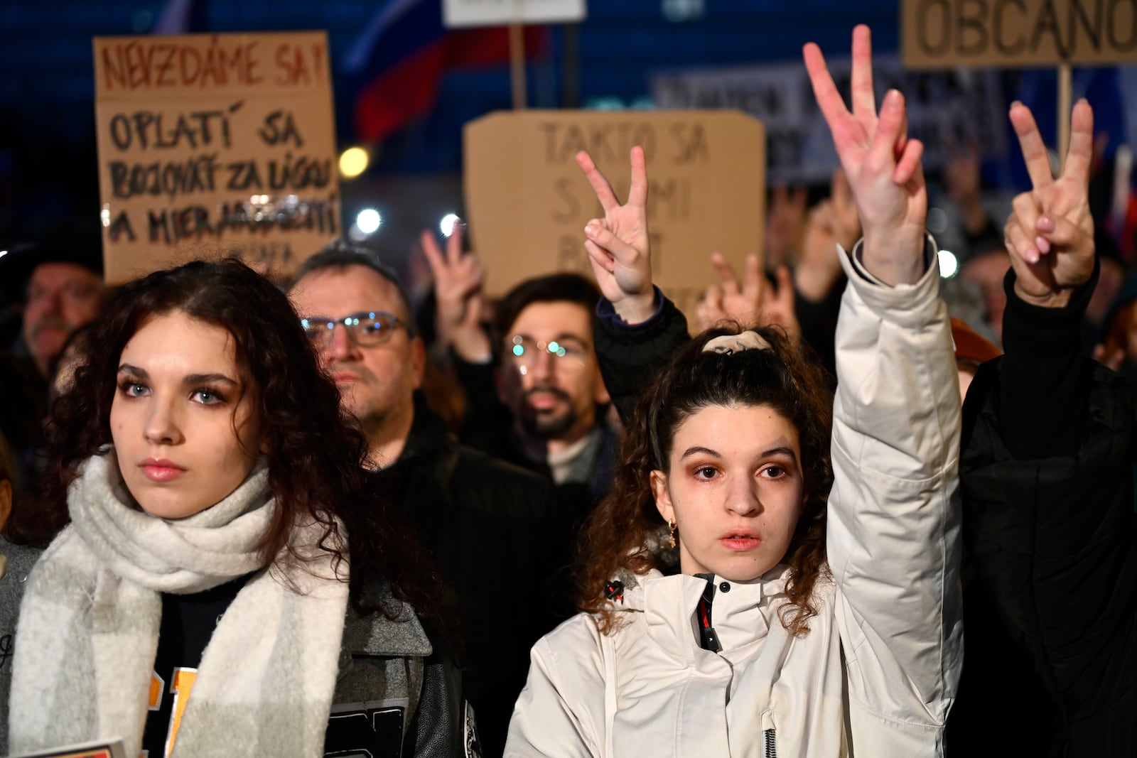 Protesters strike the v sign as thousands gather to oppose the policies of Slovakia's Prime Minister Robert Fico in Bratislava, Slovakia, Friday, Jan. 24, 2025. (AP Photo/Denes Erdos)