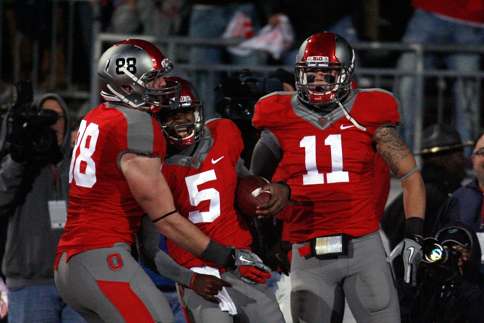 COLUMBUS, OH - OCTOBER 29:  Braxton Miller #5 of the Ohio State Buckeyes is congratulated by teammates Reid Fragel #88 and Jake Stoneburner #11 after scoring against the Wisconsin Badgers during the fourth quarter on October 29, 2011 at Ohio Stadium in Columbus, Ohio. Ohio State defeated Wisconsin 33-29. (Photo by Kirk Irwin/Getty Images)