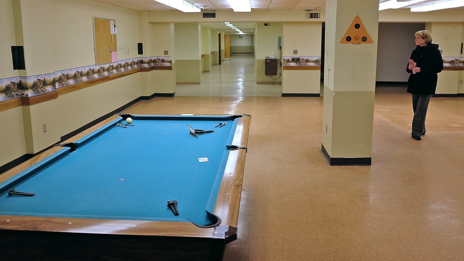 Regina Jeffers, an administrative assistant in the Springfield City Managers office, looks around the billiard room of the Myers Market building in downtown Thursday, Feb. 9, 2017. Springfield leaders are considering re-opening the former Myers Market as a year-round market, similar to the North Market in Columbus and the Second Street market in Dayton. Bill Lackey/Staff