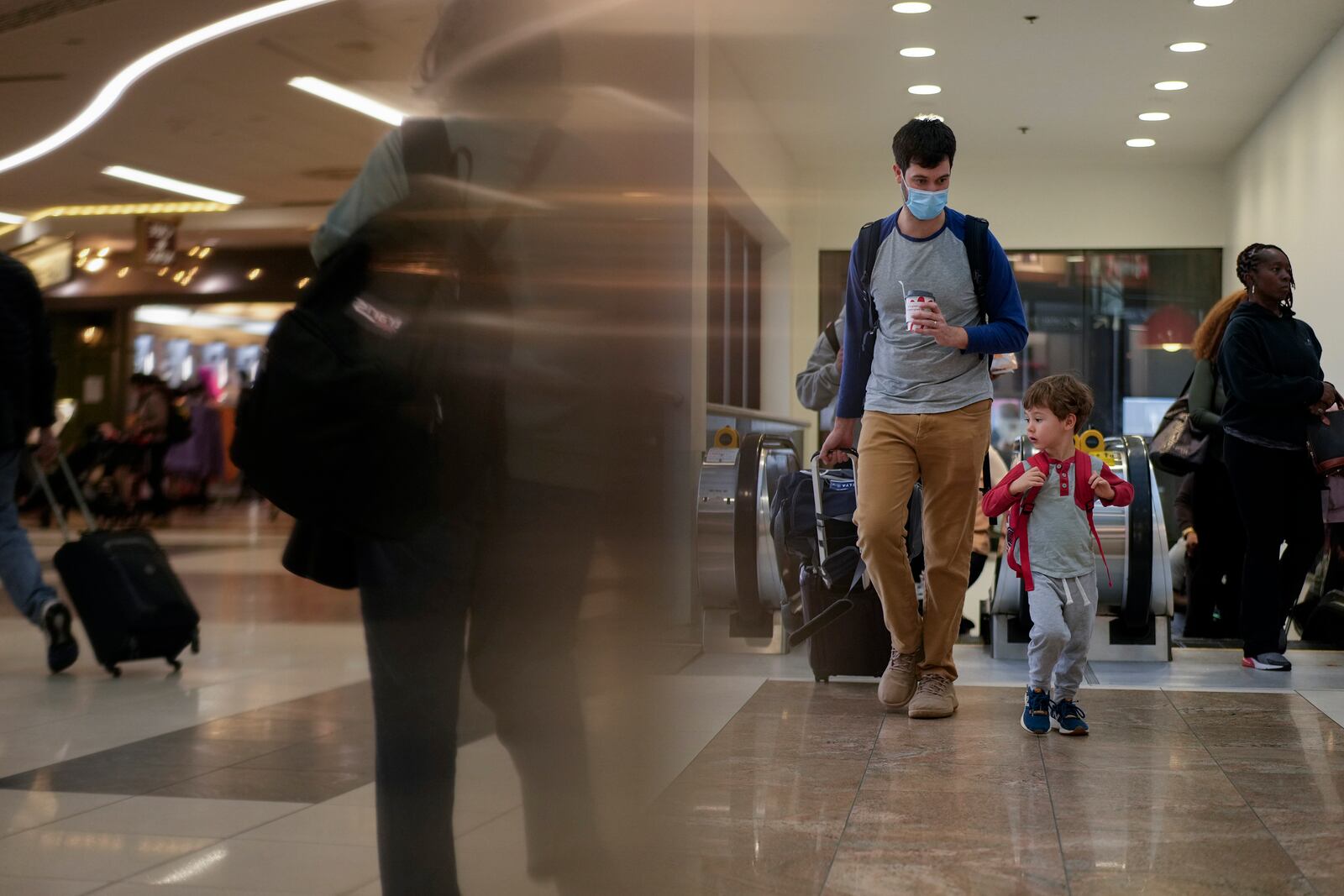 Travelers move through the B Concourse at the Hartsfield-Jackson International Airport, Tuesday, Nov. 26, 2024, in Atlanta. (AP Photo/Carolyn Kaster)