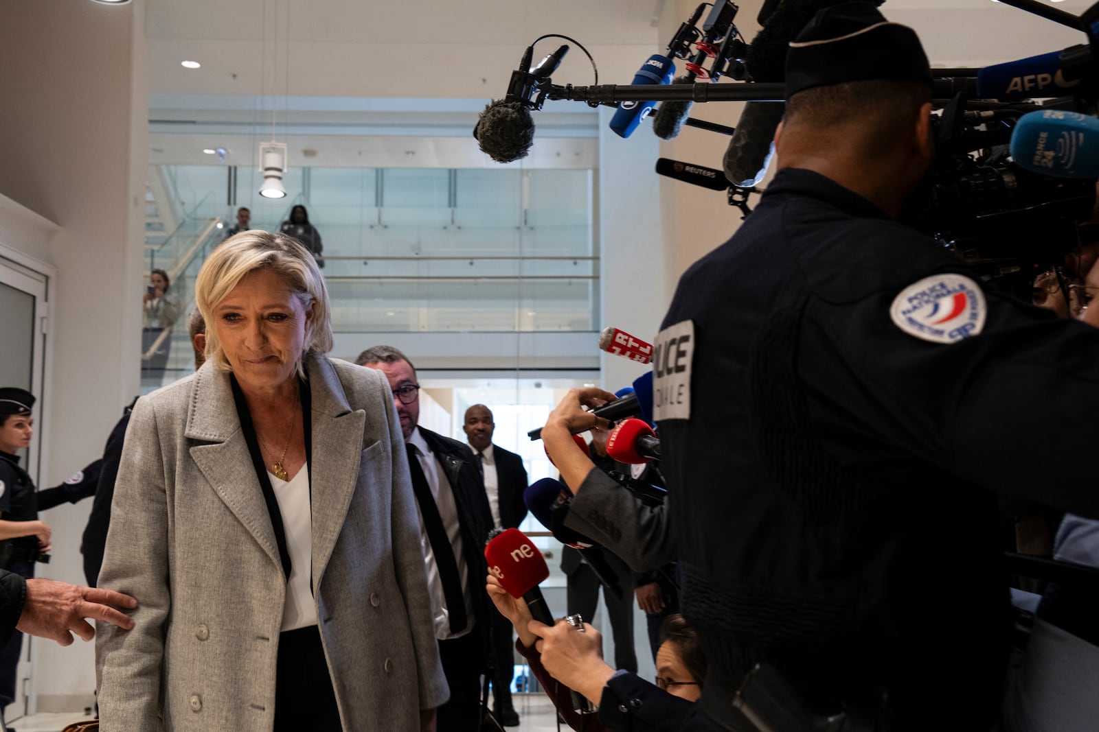 French far-right leader Marine Le Pen walks past the media as she arrives at the court house in Paris, Monday, Sept. 30, 2024. (AP Photo/Louise Delmotte)