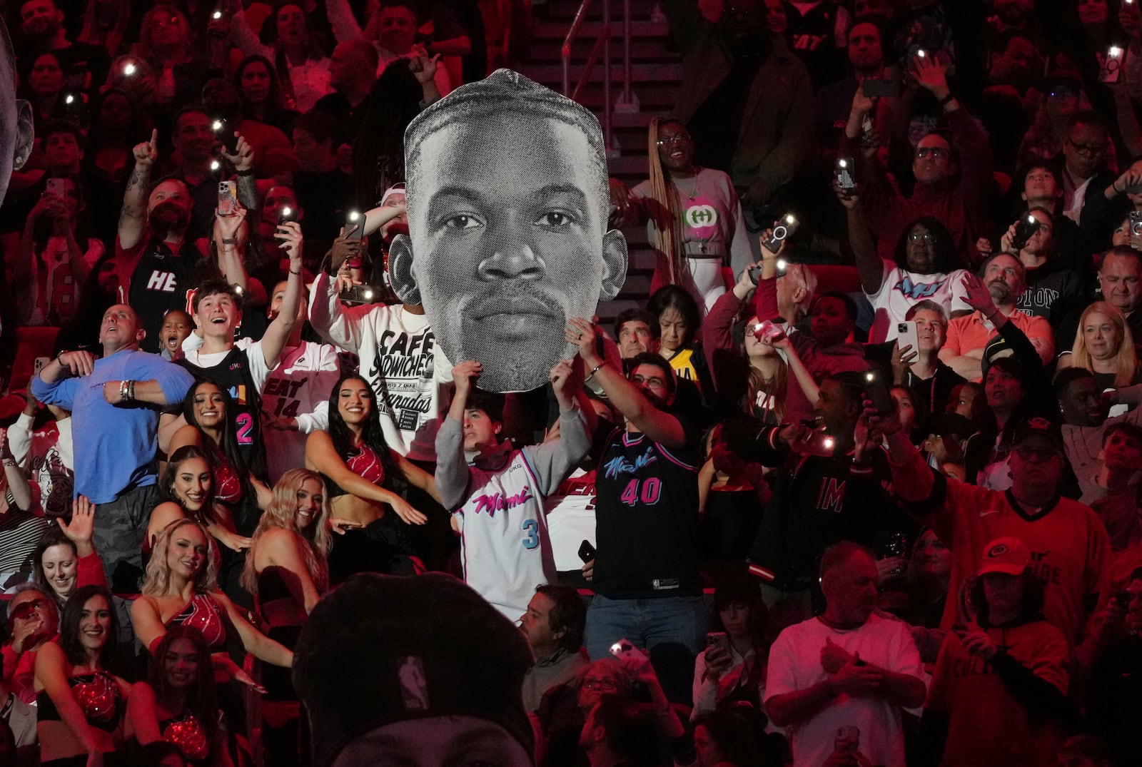 Fans hold up a portrait of Miami Heat forward Jimmy Butler during the second half of an NBA basketball game against the Indiana Pacers Thursday, Jan. 2, 2025, in Miami. (AP Photo/Lynne Sladky)