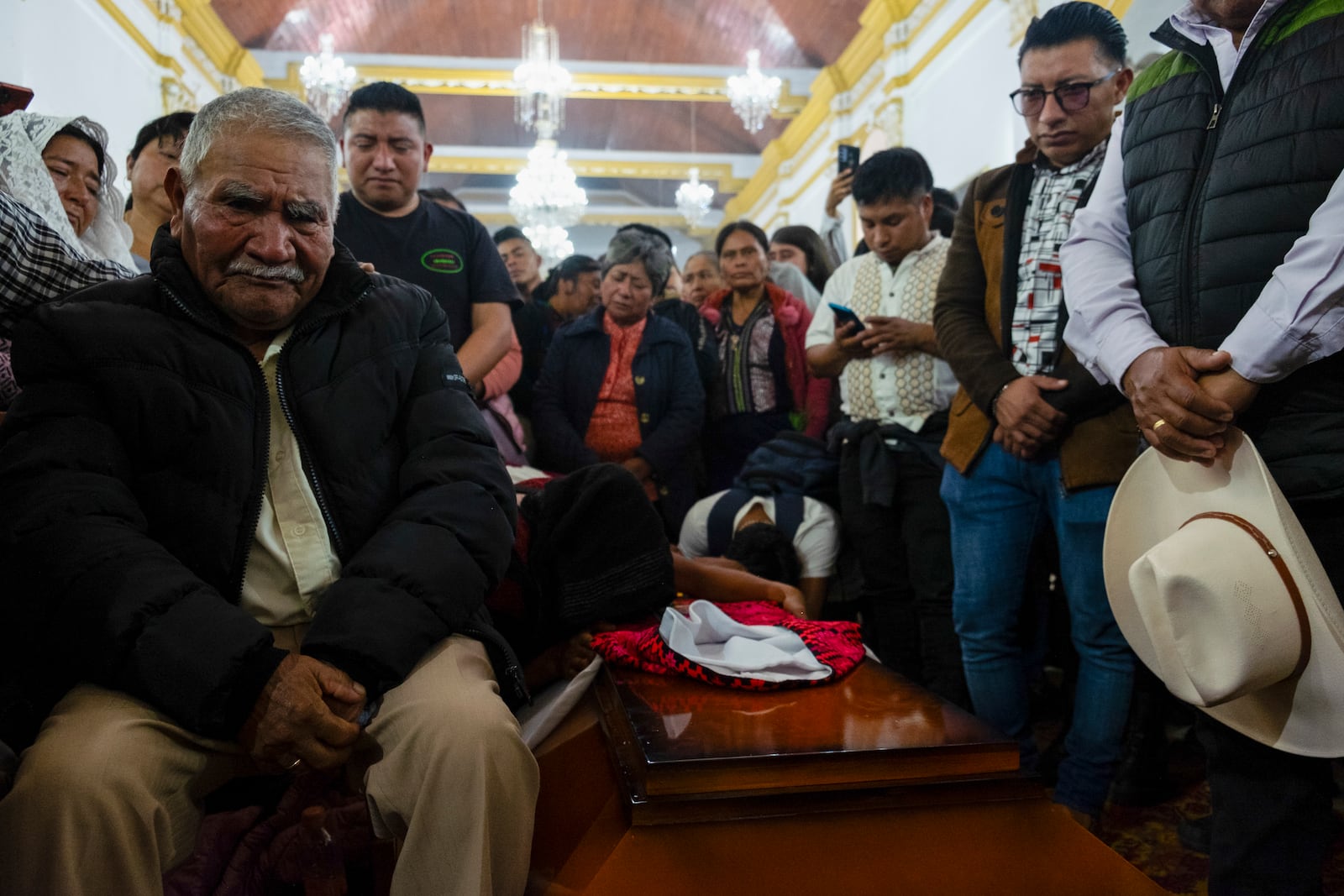 People attend a mass next to the coffin of Catholic priest Marcelo Perez, who was killed in San Cristobal de las Casas, Chiapas state, Mexico, Sunday, Oct. 20, 2024. (AP Photo/Isabel Mateos)