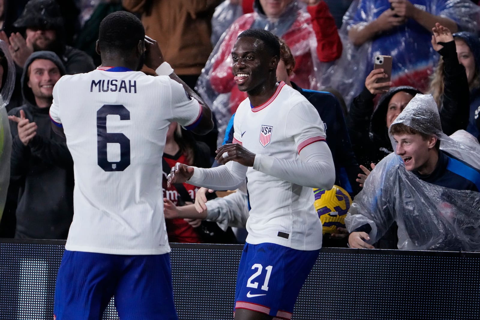 United States' Tim Weah, right, is congratulated by teammate Yunus Musah (6) after scoring during the second half in a CONCACAF Nations League quarterfinal second leg soccer match against Jamaica Monday, Nov. 18, 2024, in St. Louis. (AP Photo/Jeff Roberson)