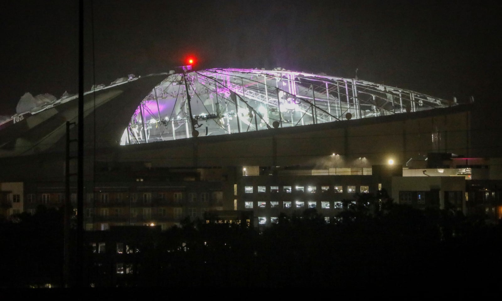 The roof of Tropicana Field, the home of the Tampa Bay Rays, appeared to be badly damaged as Hurricane Milton passes Thursday, Oct. 10, 2024, in St. Petersburg, Fla. (Chris Urso/Tampa Bay Times via AP)