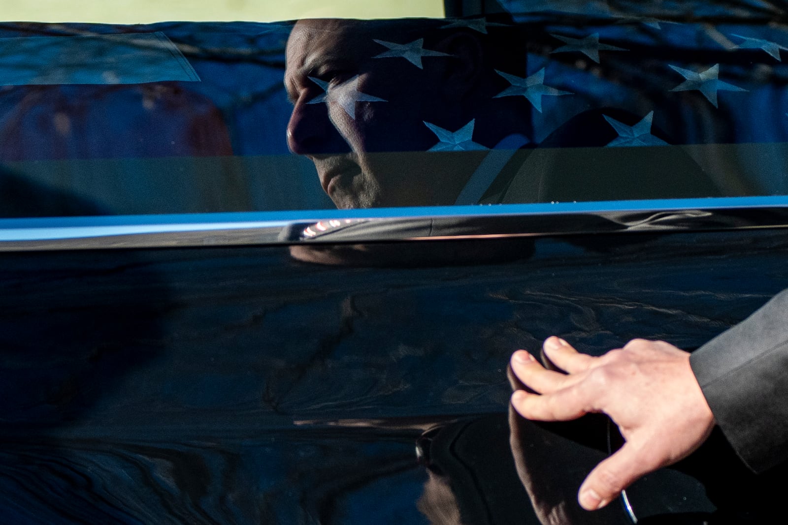 A U.S. Secret Service agent assigned to the Carter detail, places his hand on the hearse containing the casket of former President Jimmy Carter, at Phoebe Sumter Medical Center in Americus, Ga., Saturday, Jan. 4, 2025. Carter died Dec. 29 at the age of 100. (AP Photo/Alex Brandon, Pool)