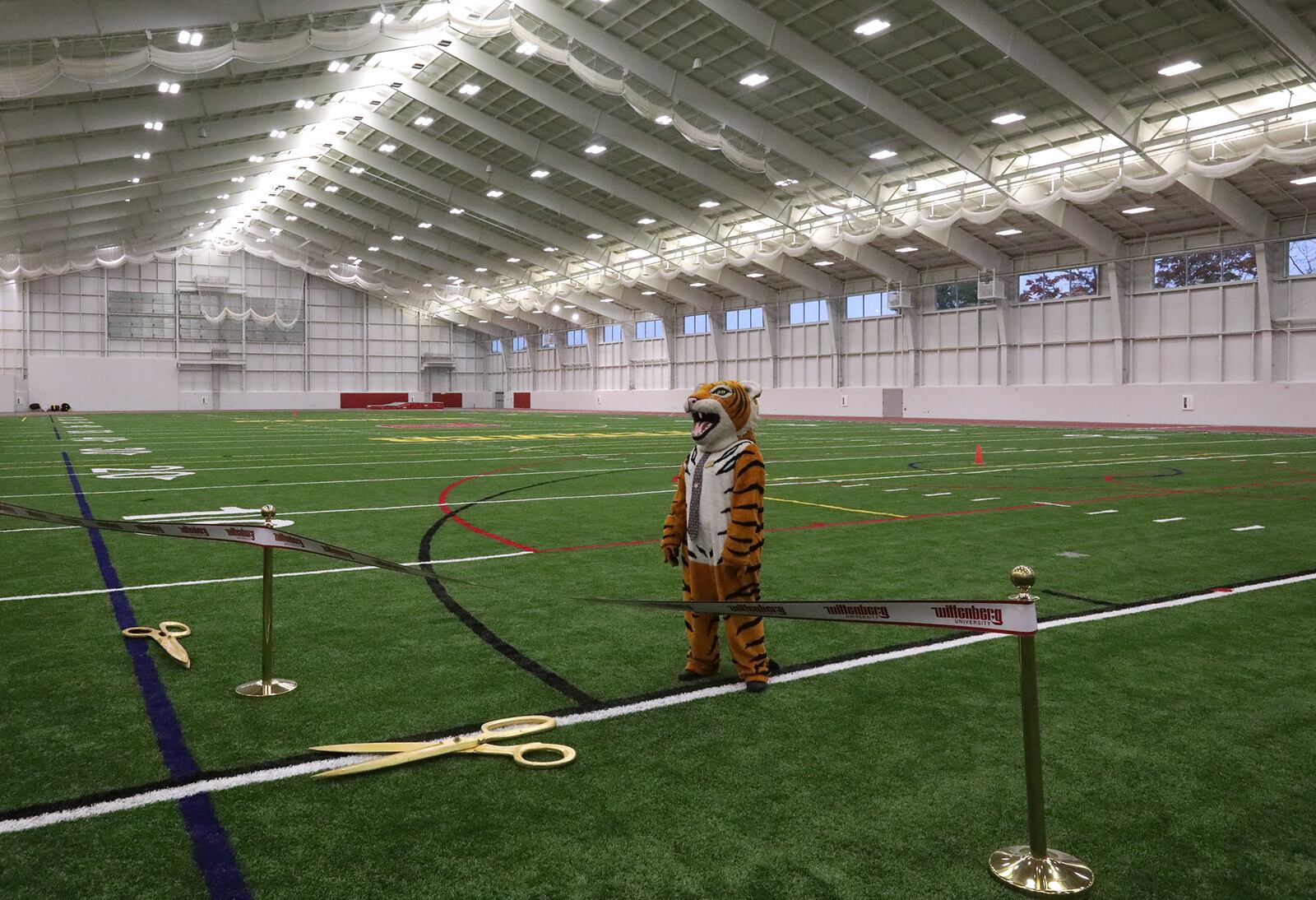 The Wittenberg Tiger waits on the athletic field in The Steemer for the other officials to join him for a ribbon cutting ceremony Friday evening. BILL LACKEY/STAFF