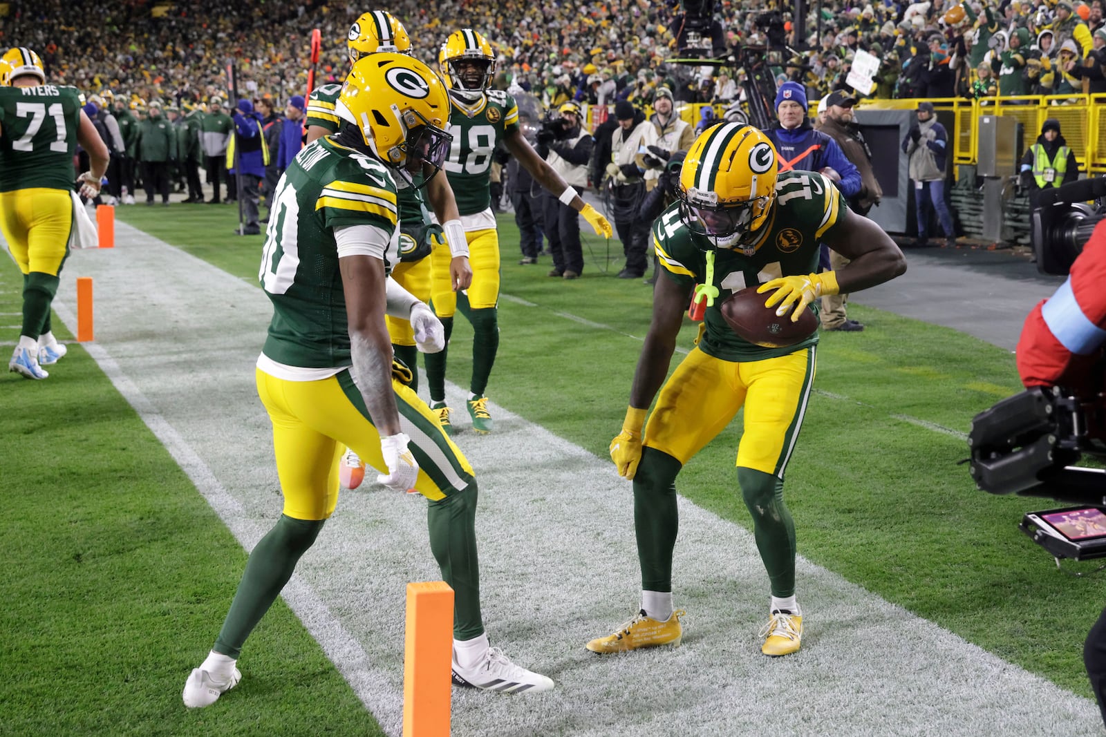 Green Bay Packers wide receiver Jayden Reed (11) celebrates after catching a 12-yard touchdown pass during the first half of an NFL football game against the Miami Dolphins Thursday, Nov. 28, 2024, in Green Bay, Wis. (AP Photo/Mike Roemer)