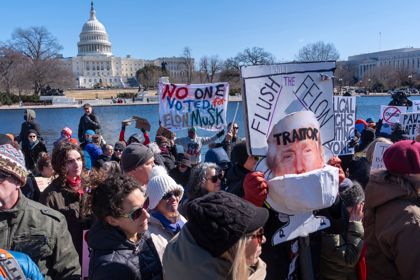 People protest as part of the "No Kings Day" protest on Presidents Day in Washington, against President Donald Trump and Elon Musk, Monday, Feb. 17, 2025, by the Capitol in Washington. The protest was organized by the 50501 Movement, which stands for 50 Protests 50 States 1 Movement. (AP Photo/Jacquelyn Martin)