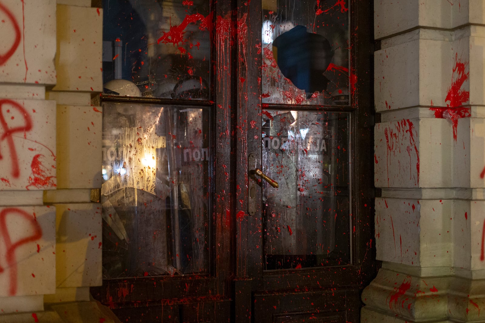 Riot police stand guard inside the City Hall building during a protest in Novi Sad, Serbia, Tuesday, Nov. 5, 2024. (AP Photo/Marko Drobnjakovic)