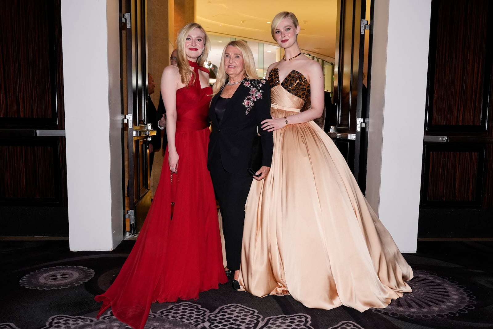 Dakota Fanning, left, and Elle Fanning, right, pose with their grandmother at the 82nd Golden Globes on Sunday, Jan. 5, 2025, at the Beverly Hilton in Beverly Hills, Calif. (AP Photo/Chris Pizzello)