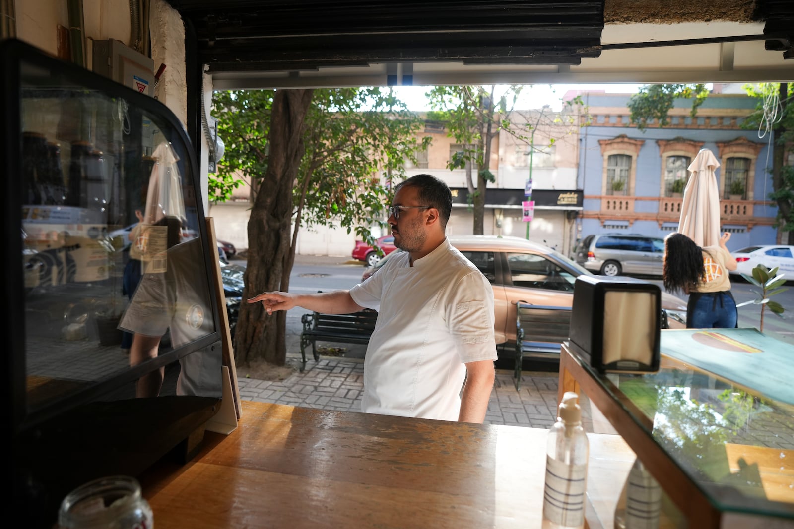 Manu Tovar opens the doors of his bakery to sell pan de muerto, or "bread of the dead," traditional for Mexico's Day of the Dead, in the San Rafael neighborhood of Mexico City, Thursday, Oct. 17, 2024. (AP Photo/Fernando Llano)