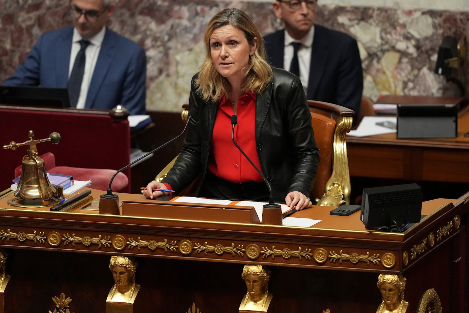 National Assembly president Yaël Braun-Pivet announces the results after France's far-right and left-wing lawmakers joined together to vote a no-confidence motion prompted by budget disputes that forces Prime Minister Michel Barnier to resign, Wednesday, Dec. 4, 2024 in Paris. (AP Photo/Michel Euler)