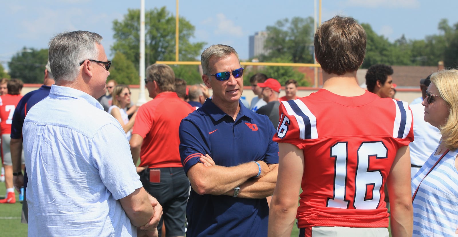 Offensive coordinator Jim Collins talks to the family of quarterback Spencer Hawkins at Dayton Flyers football photo day at Welcome Stadium on Sunday, Aug. 22, 2021. David Jablonski/Staff