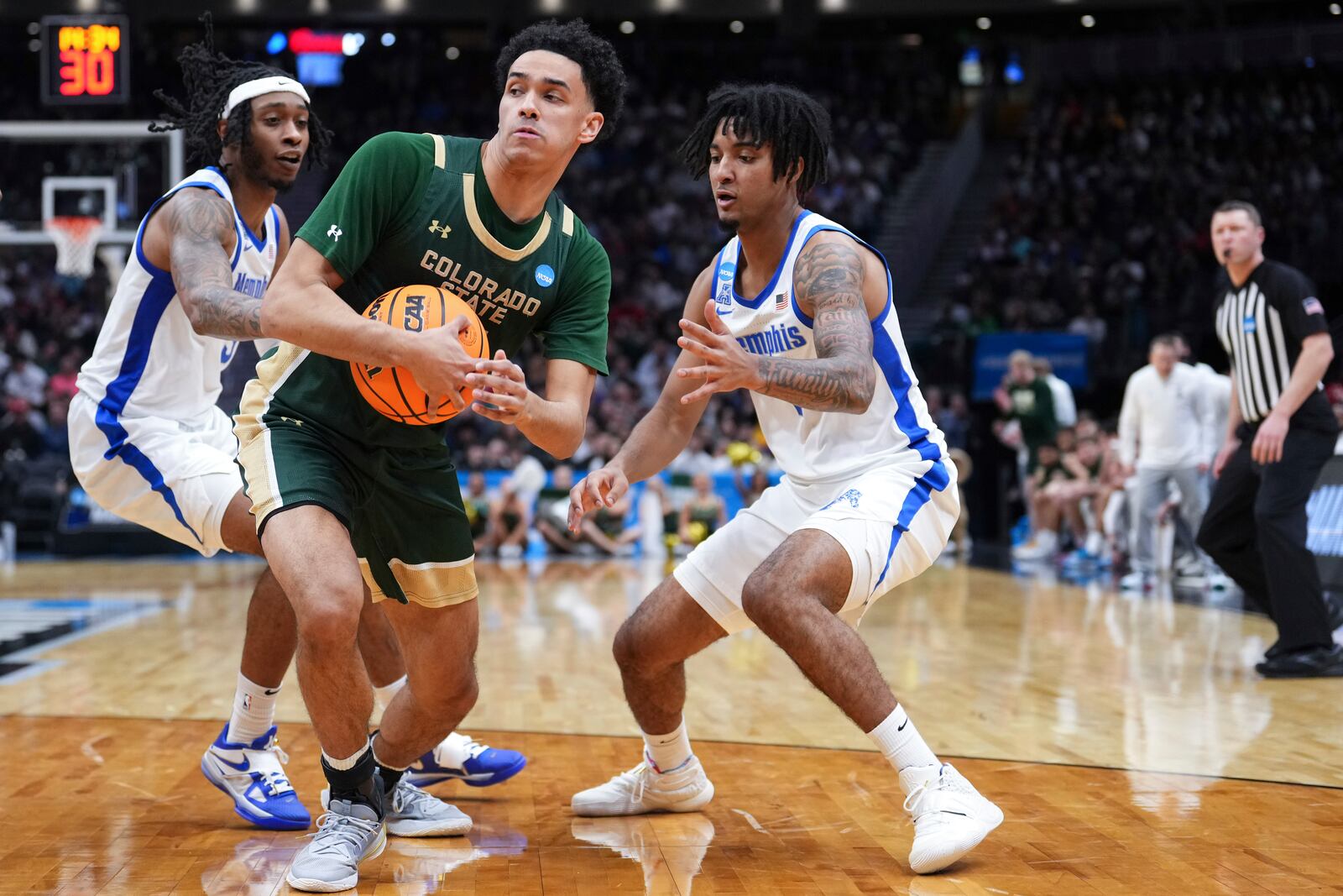 Colorado State guard Jalen Lake, center, tries to keep possession against Memphis guard Colby Rogers, left, and guard PJ Haggerty, right, during the second half in the first round of the NCAA college basketball tournament, Friday, March 21, 2025 in Seattle. (AP Photo/Lindsey Wasson)