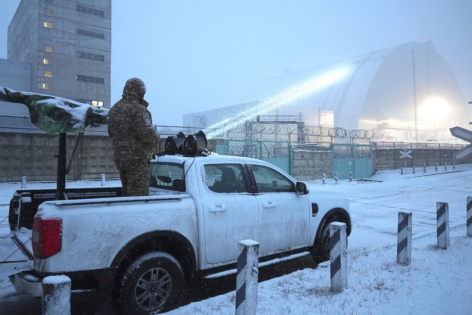 Ukrainian serviceman stands on a vehicle with anti-aircraft gun after a drone attack at the former Chernobyl nuclear power plant, Ukraine, Friday, Feb. 14, 2025. (AP Photo/Efrem Lukatsky)