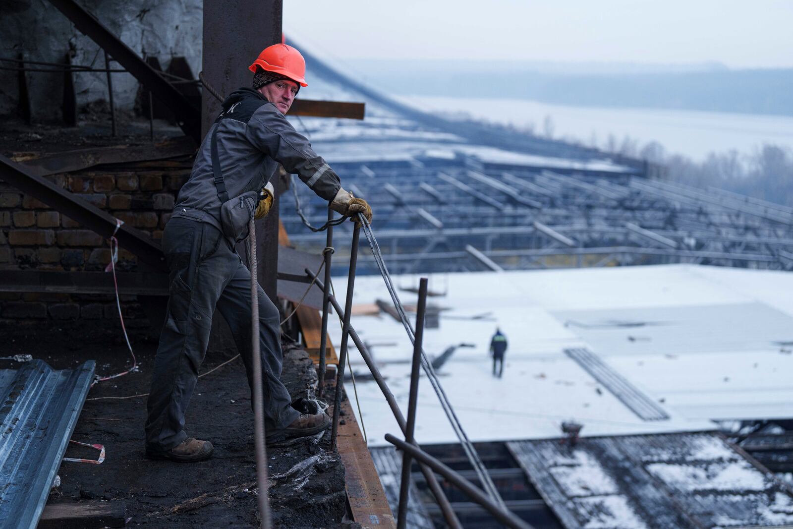 A worker stands on a roof of a DTEK's power plant after a recent Russian missile attack in Ukraine, Nov. 28, 2024. (AP Photo/Evgeniy Maloletka)