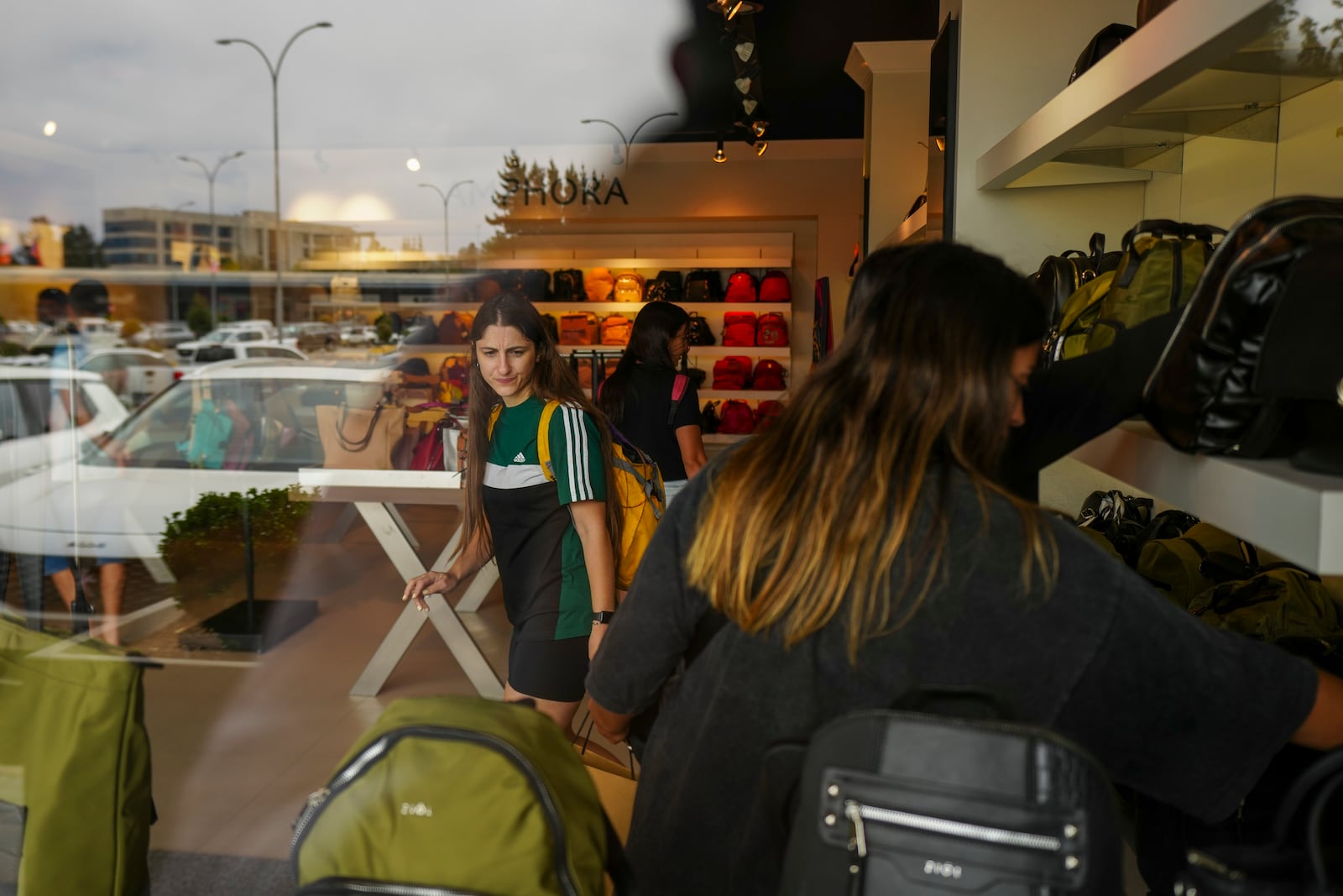 Argentine tourist Ana Laura Termini shops with friends at a mall in the seaside town of Renaca in Vina del Mar, Chile, Thursday, Jan. 30, 2025. (AP Photo/Esteban Felix)