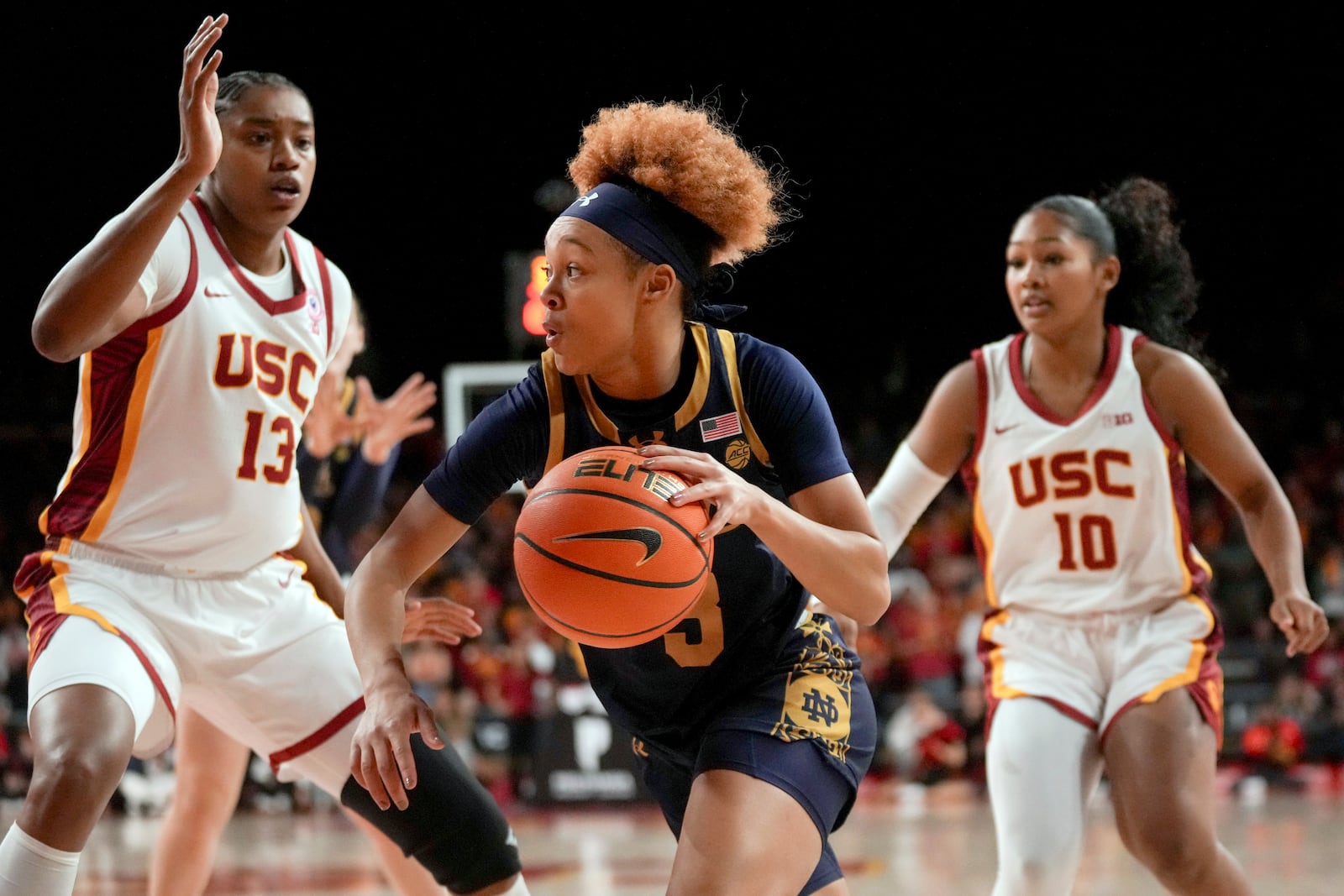 Notre Dame guard Hannah Hidalgo (3) dribbles against Southern California center Rayah Marshall (13) and guard Malia Samuels (10) during the first half of an NCAA college basketball game, Saturday, Nov. 23, 2024 in Los Angeles. (AP Photo/Eric Thayer)