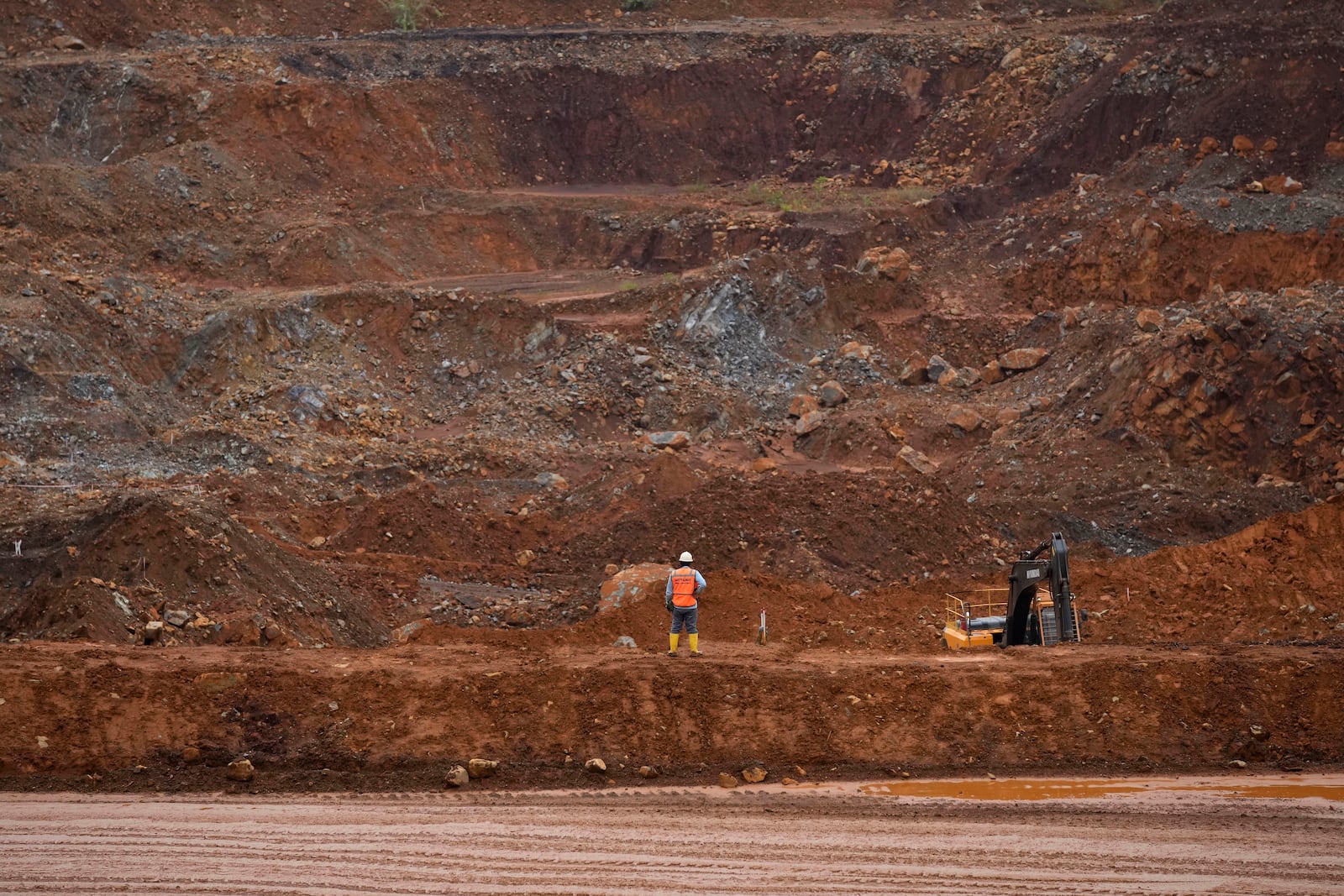 FILE - A worker stands near a mining pit at PT Vale Indonesia's nickel mine in Sorowako, South Sulawesi, Indonesia, on Sept. 12, 2023. (AP Photo/Dita Alangkara, File)