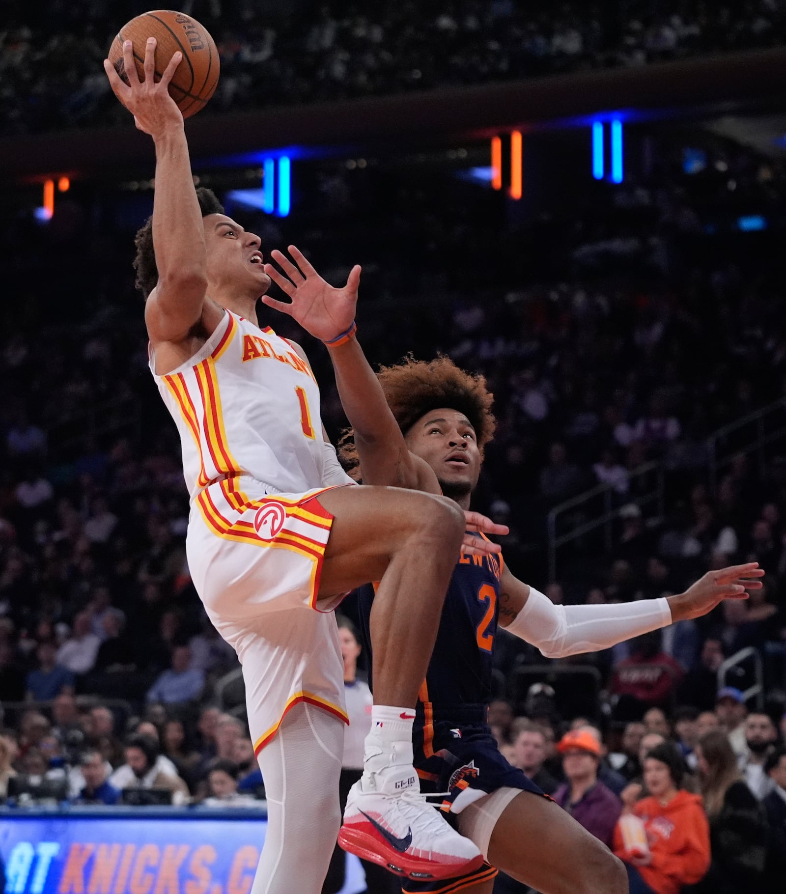 Atlanta Hawks' Jalen Johnson (1) drives past New York Knicks' Miles McBride (2) during the first half of an Emirates NBA Cup basketball game Wednesday, Dec. 11, 2024, in New York. (AP Photo/Frank Franklin II)