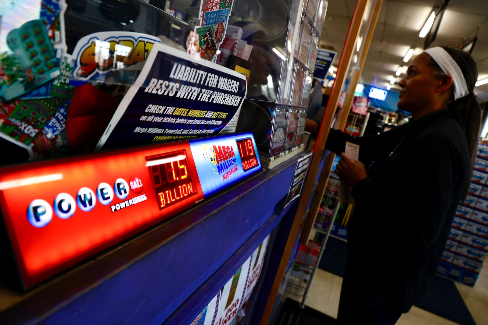 Ora Weaver tries her luck at the estimated $1.6 billion Powerball jackpot Friday, Nov. 4, 2022, at the Plum Food Mart in Springfield. BILL LACKEY/STAFF