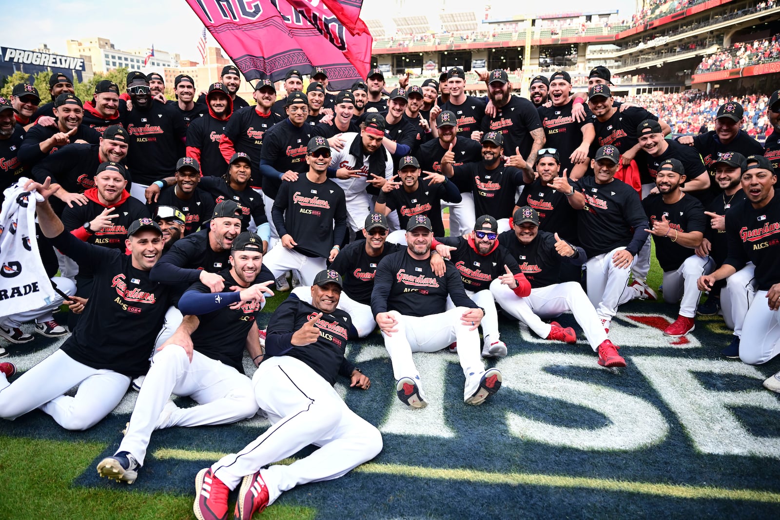 The Cleveland Guardians celebrate after the Guardians defeated the Tigers in Game 5 of baseball's American League Division Series, Saturday, Oct. 12, 2024, in Cleveland. (AP Photo/David Dermer)