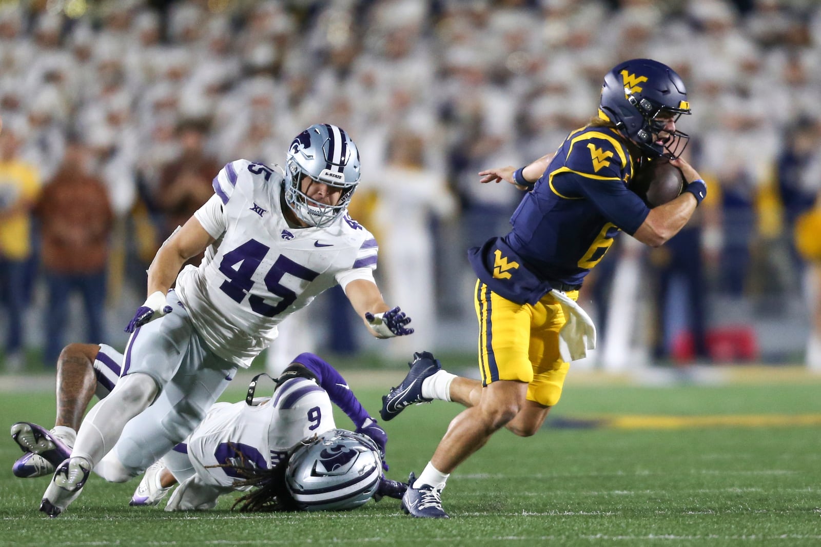 West Virginia quarterback Garrett Greene (6) runs against Kansas State during the first half of an NCAA college football game, Saturday, Oct. 19, 2024, in Morgantown, W.Va. (AP Photo/William Wotring)