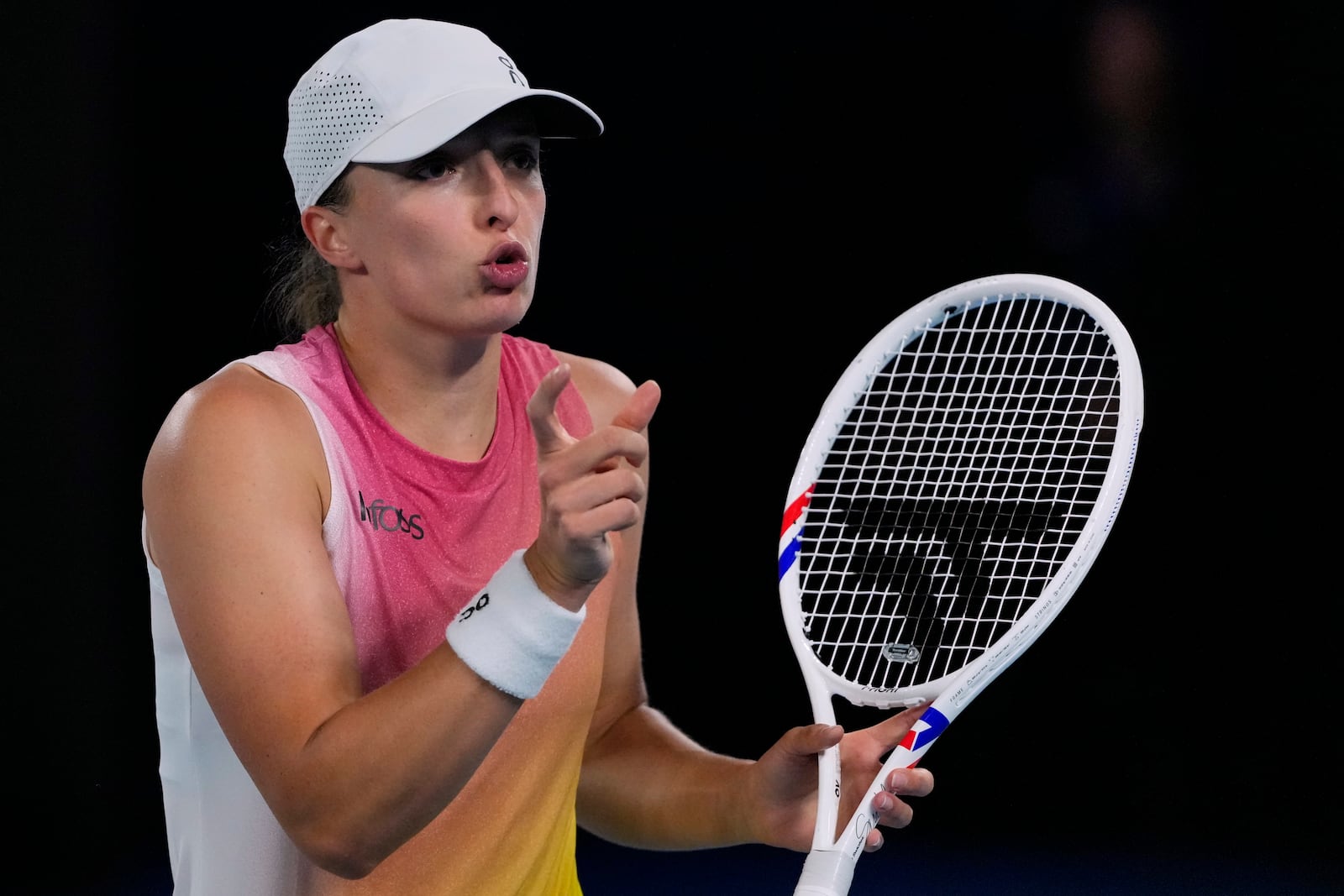 Iga Swiatek of Poland reacts during her semifinal match against Madison Keys of the U.S. at the Australian Open tennis championship in Melbourne, Australia, Thursday, Jan. 23, 2025. (AP Photo/Vincent Thian)