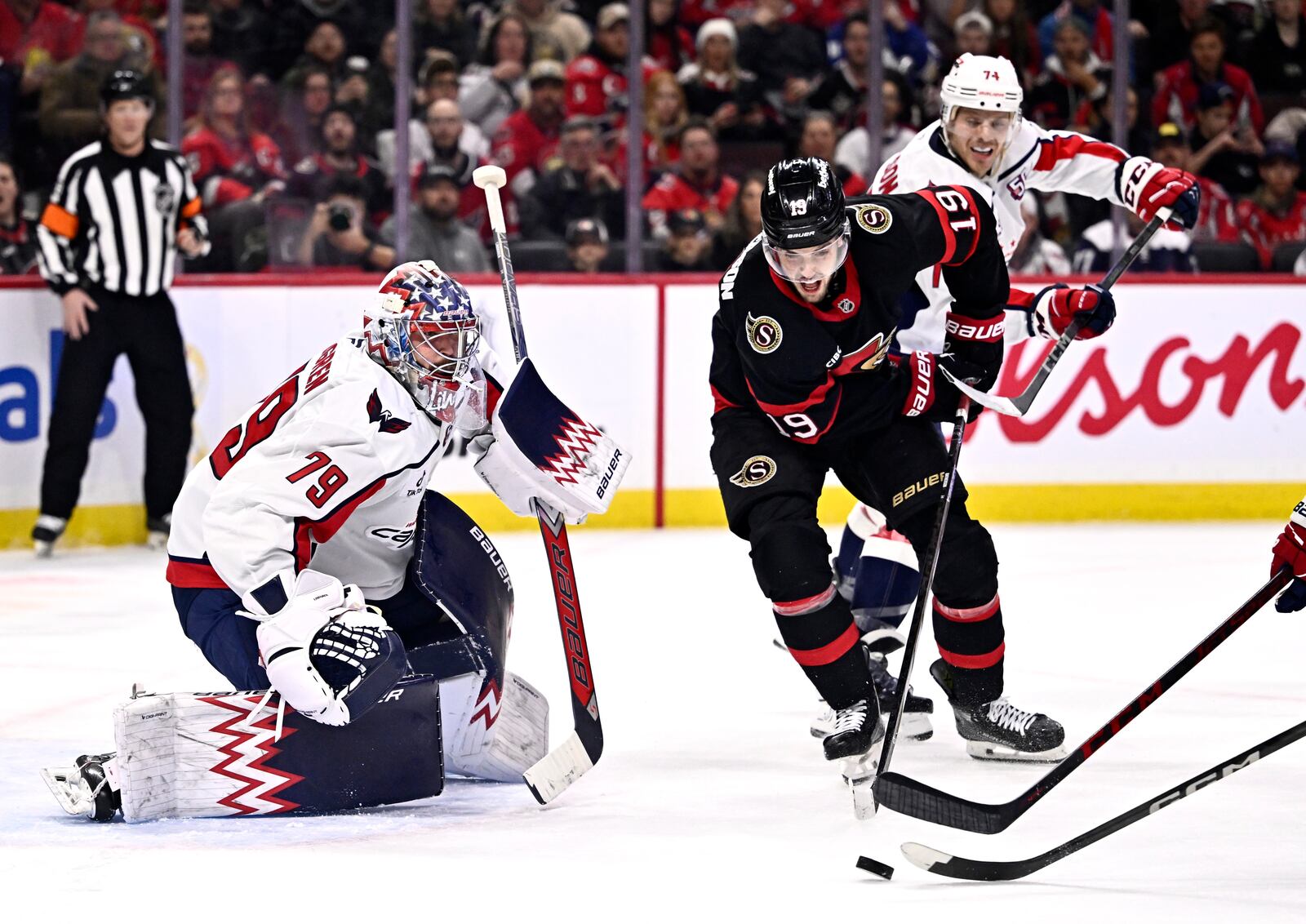 Ottawa Senators' Drake Batherson (19) tries to control the puck in front of Washington Capitals goaltender Charlie Lindgren (79) during second period NHL hockey action in Ottawa, on Thursday, Jan. 30, 2025. (Justin Tang/The Canadian Press via AP)